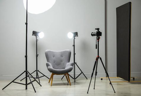 Professional lighting equipment and armchair in photo studio